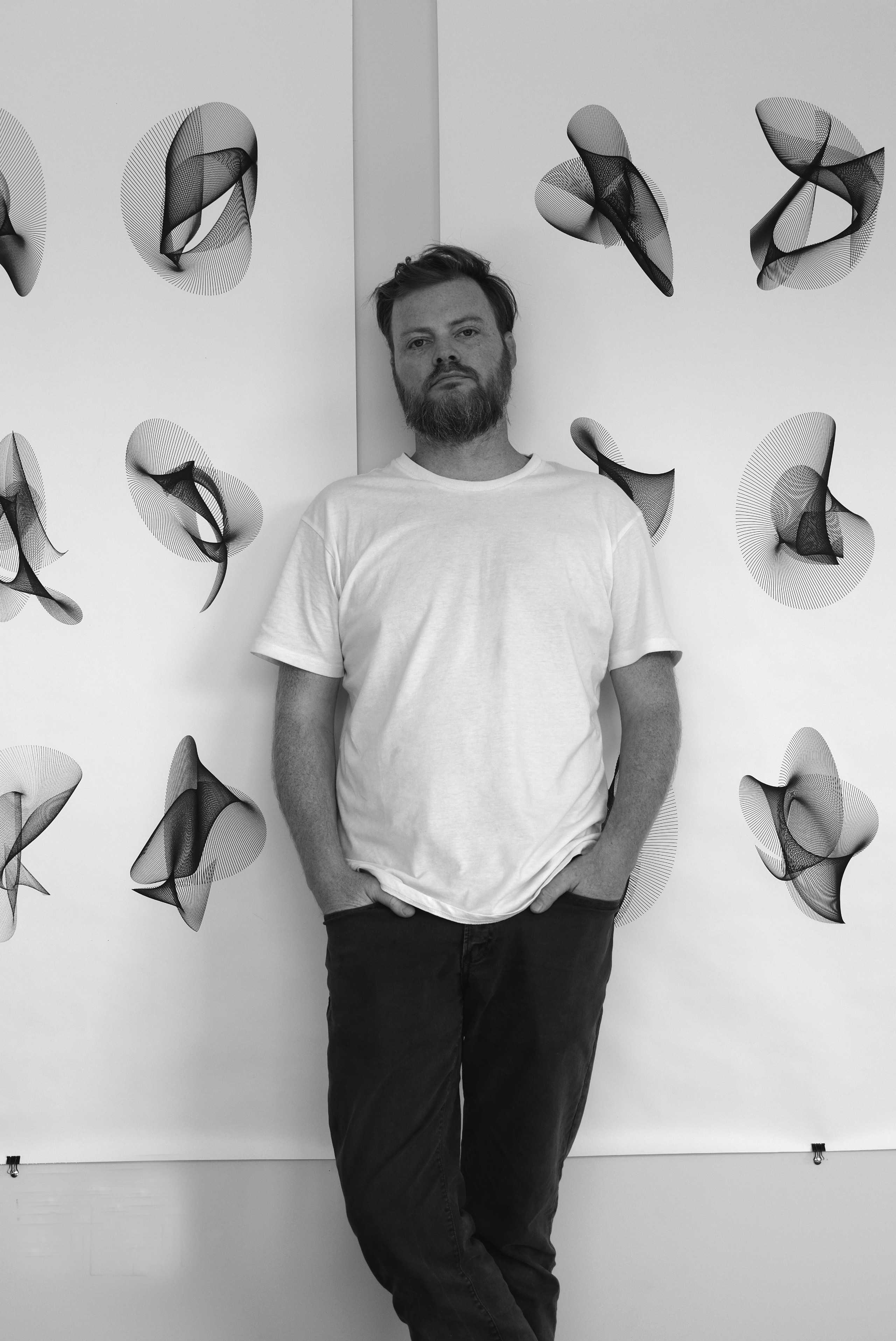 artist standing in front of work in studio